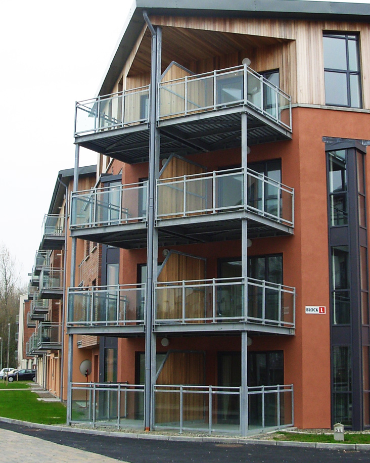 Modern building showing steel and glass balconies.