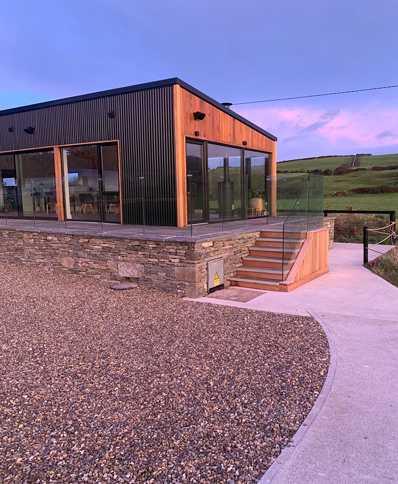 Home in countryside showing steel and glass construction.